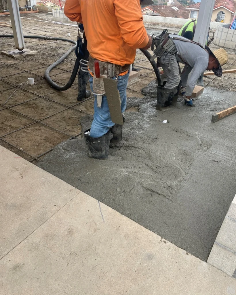 landscapers leveling new concrete and pavers in orange county